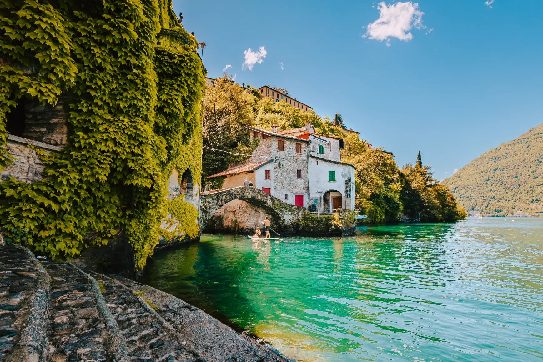 village-of-nesso-with-couple-of-people-on-surfboar-2024-12-08-05-42-59-utc